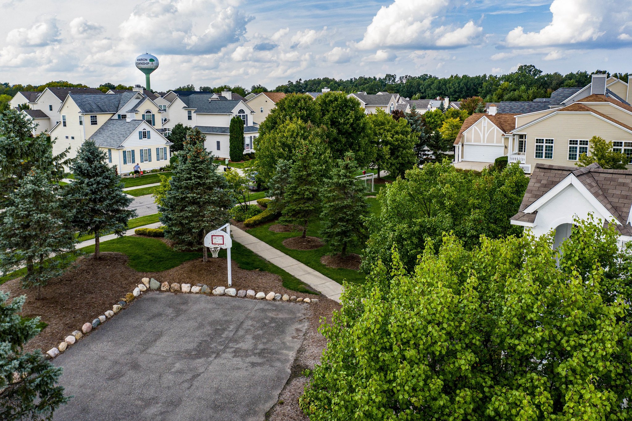 A Family Neighborhood With A Basketball Court